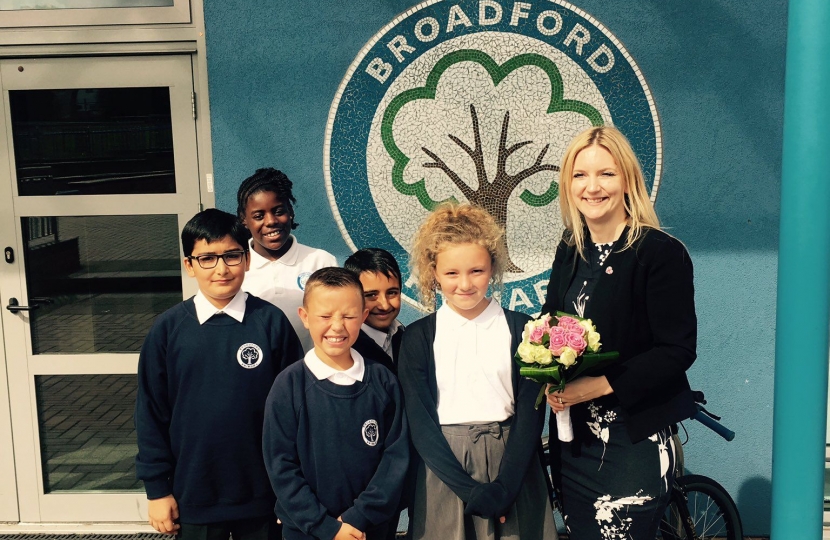 Julia at Broadford Primary stood in front of the school logo.