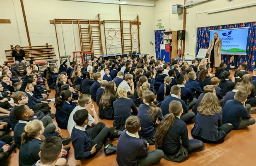 Julia speaking to an assembly of children at Hilldene.