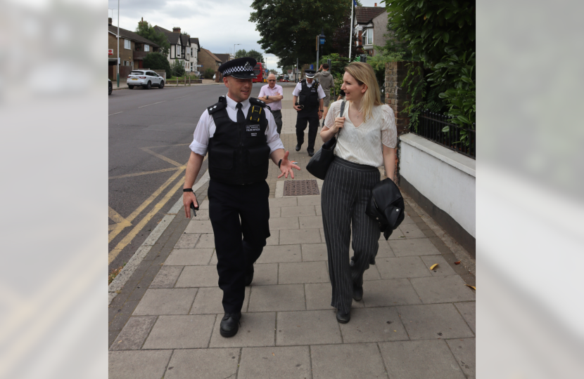 Julia walking down the street with a police officer.