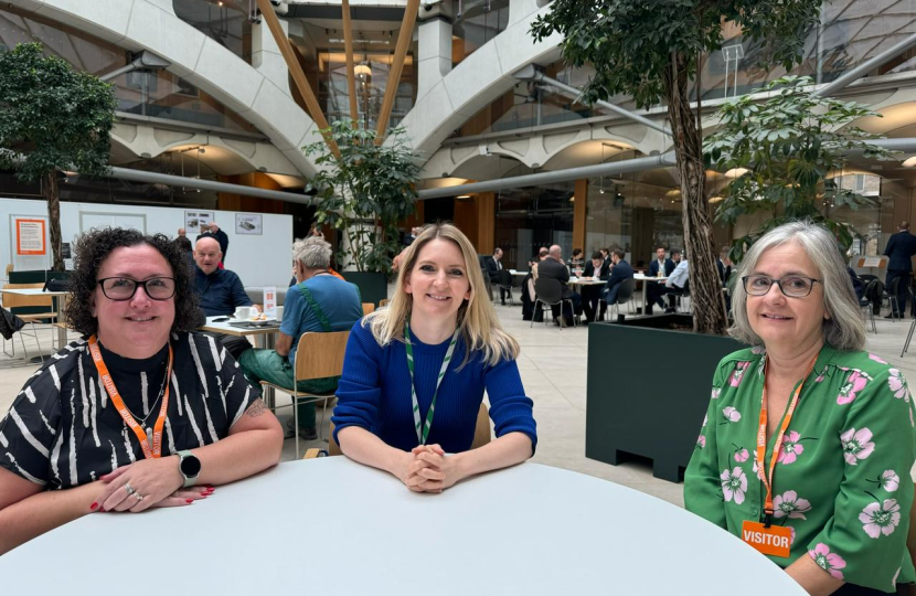 Julia Lopez with two of the debt coaches at a table in Portcullis House