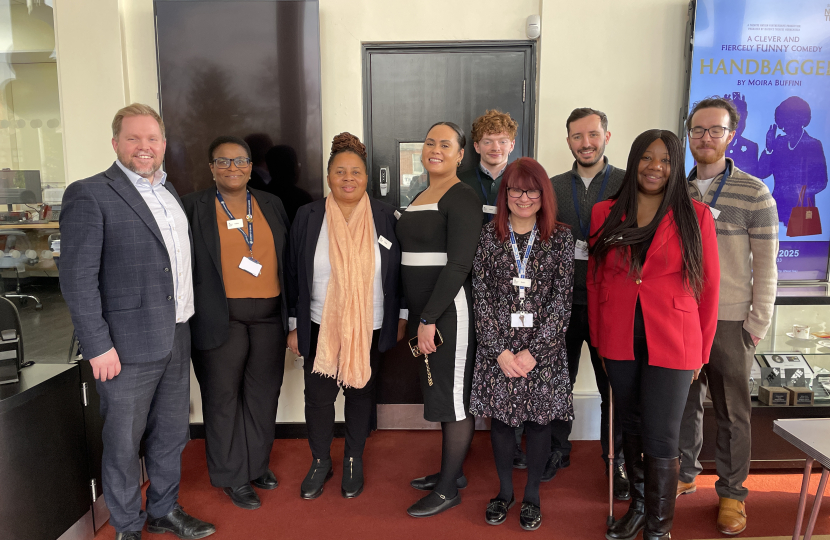 A member of Julia's team having a photo with the wider Job Centre team.