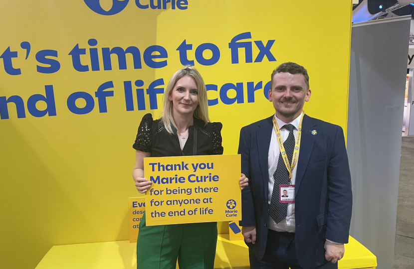 Julia smiling for a photo with Marie Curie UK