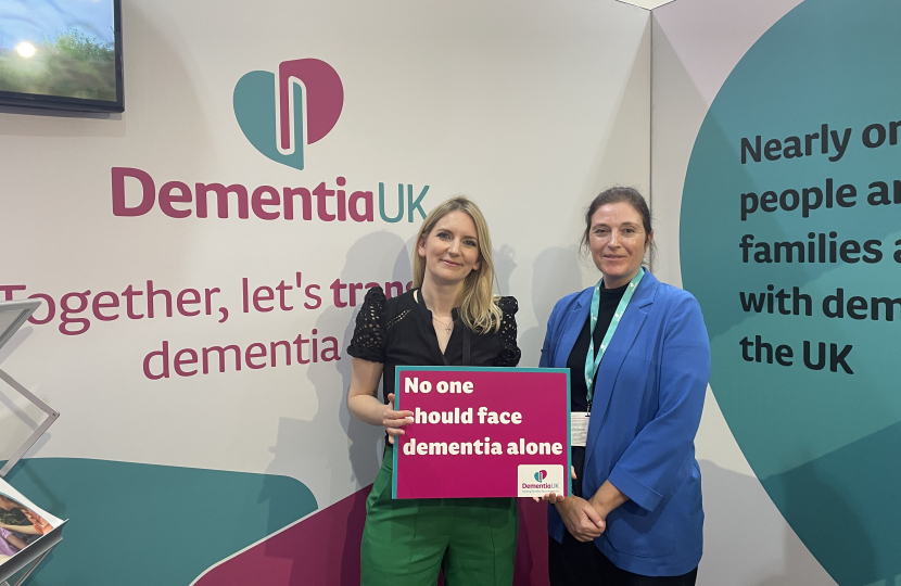 Julia smiling for a photo with a lady from Dementia UK