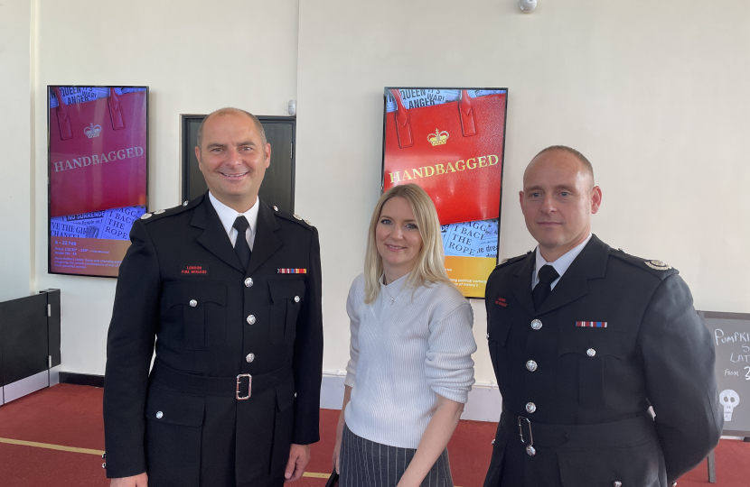 Julia Lopez with Fire Officers at the Older People's Fair at Queen's Theatre Hornchurch