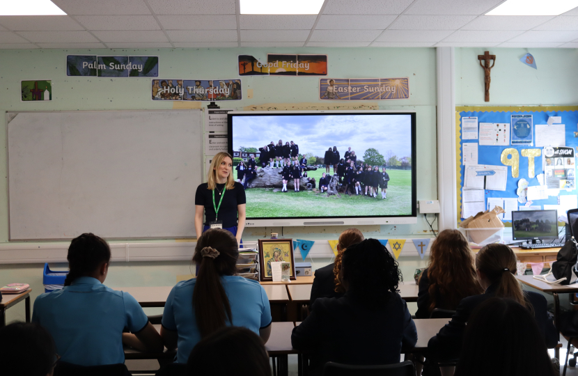 Photo of Julia speaking to pupils at Sacred Heart during her May visit last year. The photo is taken from the back of the classroom.