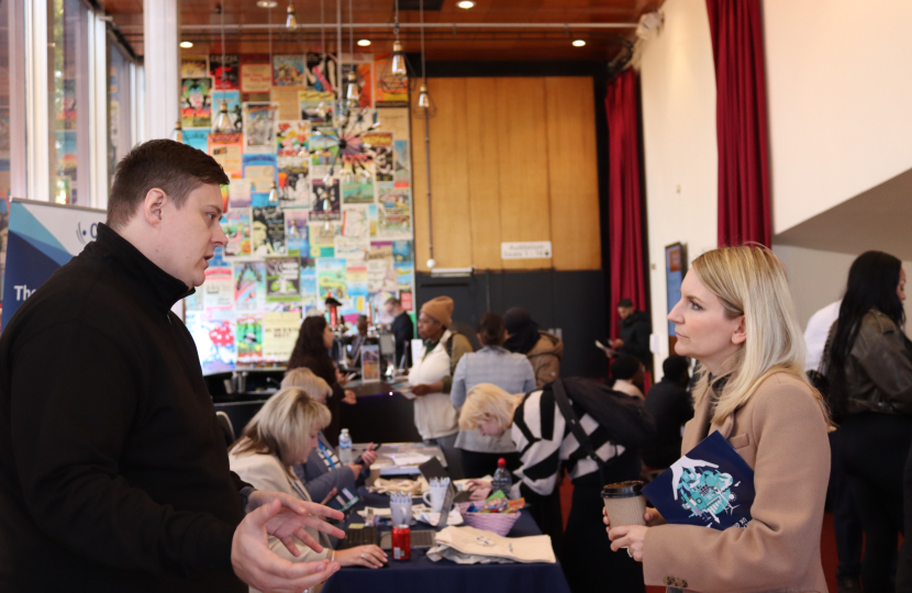 Julia Lopez MP talking with employers at the Jobs, Skills and Apprenticeship Fair