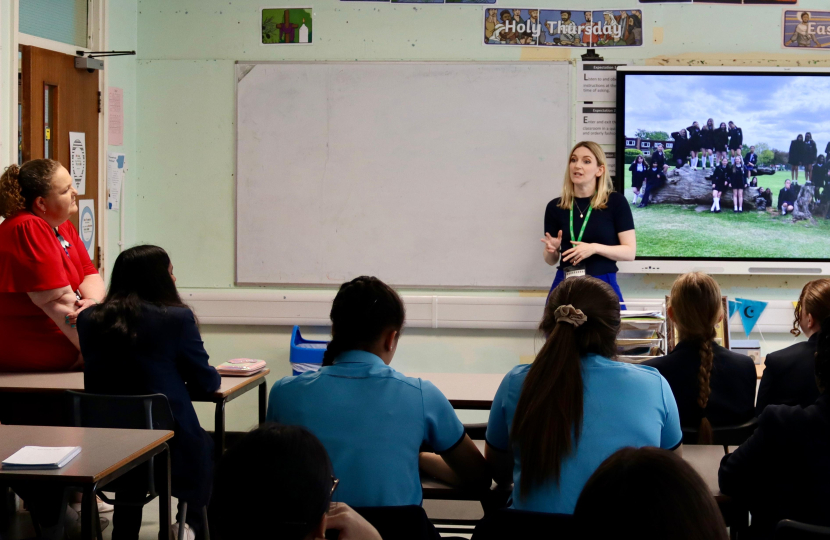 Photo of Julia speaking to pupils at Sacred Heart during her May visit last year. The photo is taken from the back of the classroom.