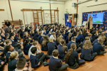 Julia speaking to an assembly of children at Hilldene.