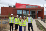 Julia at St. George's NHS Hub a month ahead of it's opening with others involved in the construction project.