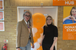 Photo of Julia and Grazina in front of an orange balloon to celebrate 40 years of the hospice during Julia's visit.