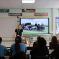 Photo of Julia speaking to pupils at Sacred Heart during her May visit last year. The photo is taken from the back of the classroom.