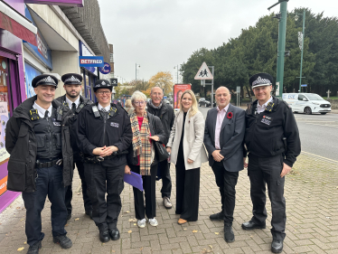 Julia, Keith Prince AM, community activists and the police smiling for a photo together on Upminster High Street